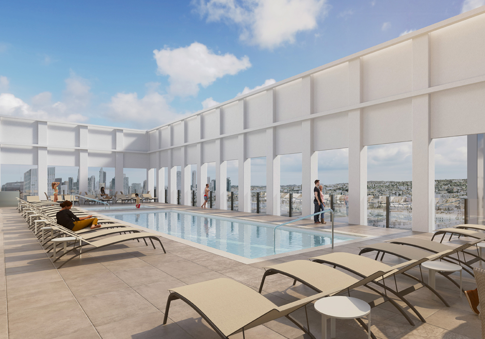 Rooftop deck with outdoor dining seating and BBQs with view of downtown Los Angeles skyline.